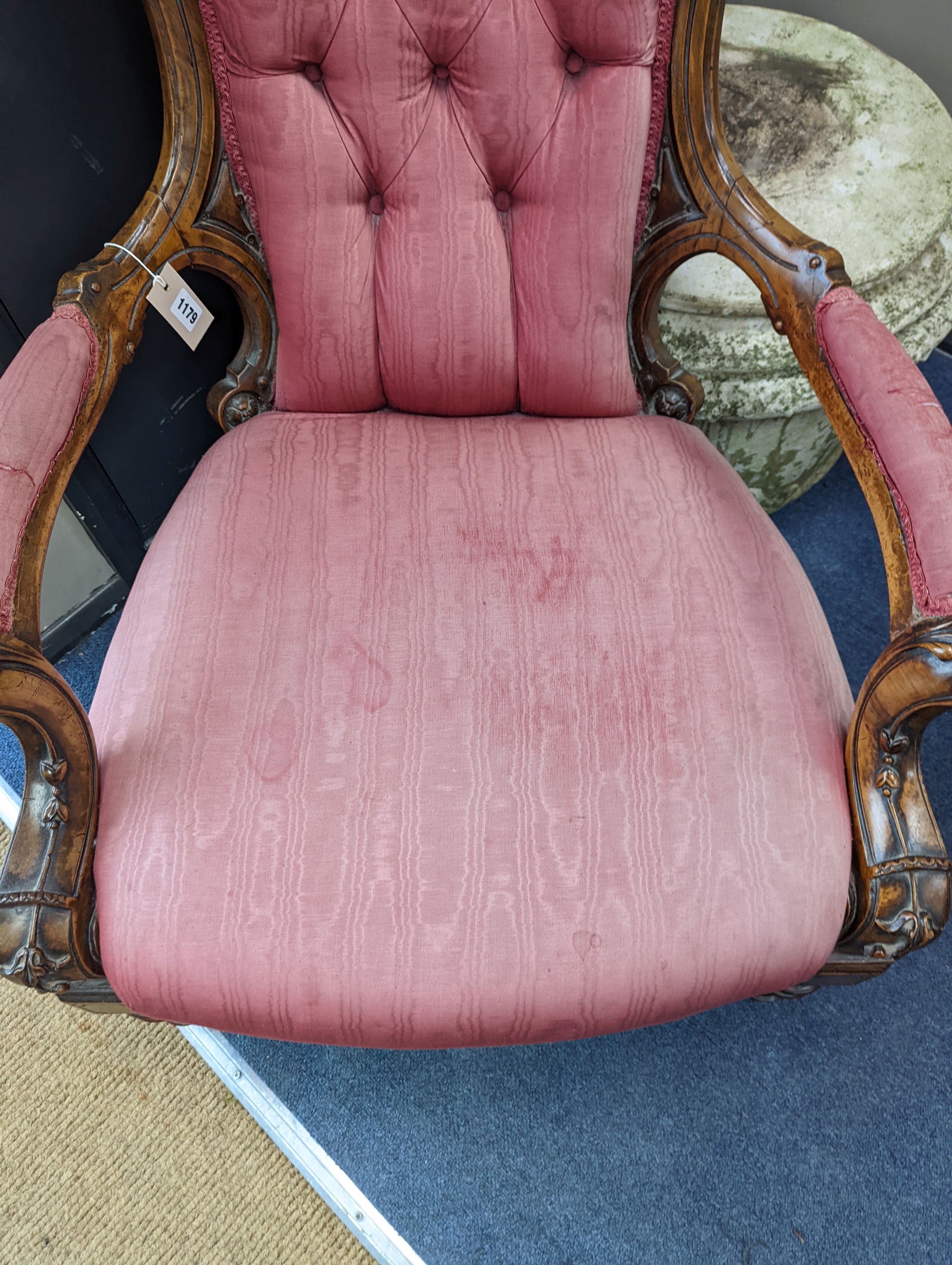 A Victorian carved walnut open armchair